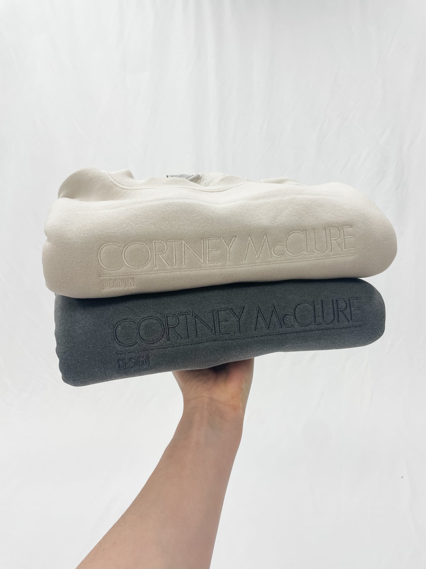 Two sweatshirts with custom embroidered logo