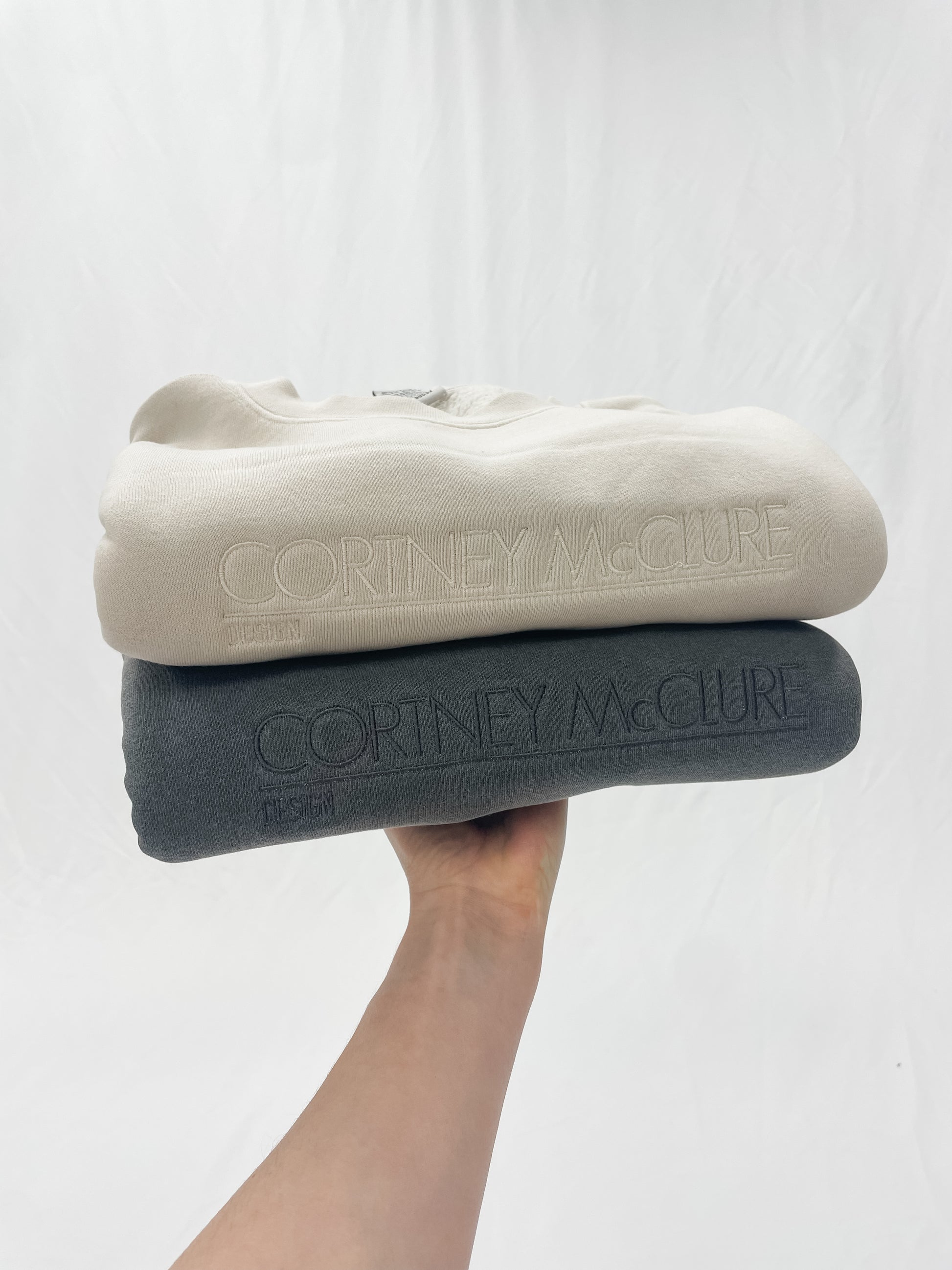 Two sweatshirts with custom embroidered logo