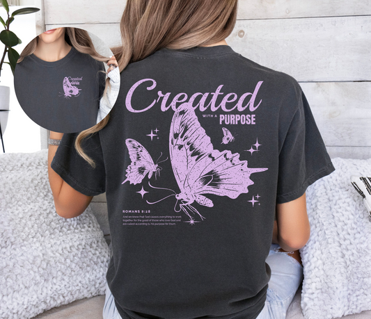 Back and front of shirt feature a butterfly in purple and words created with a purpose referencing Romans 8:28