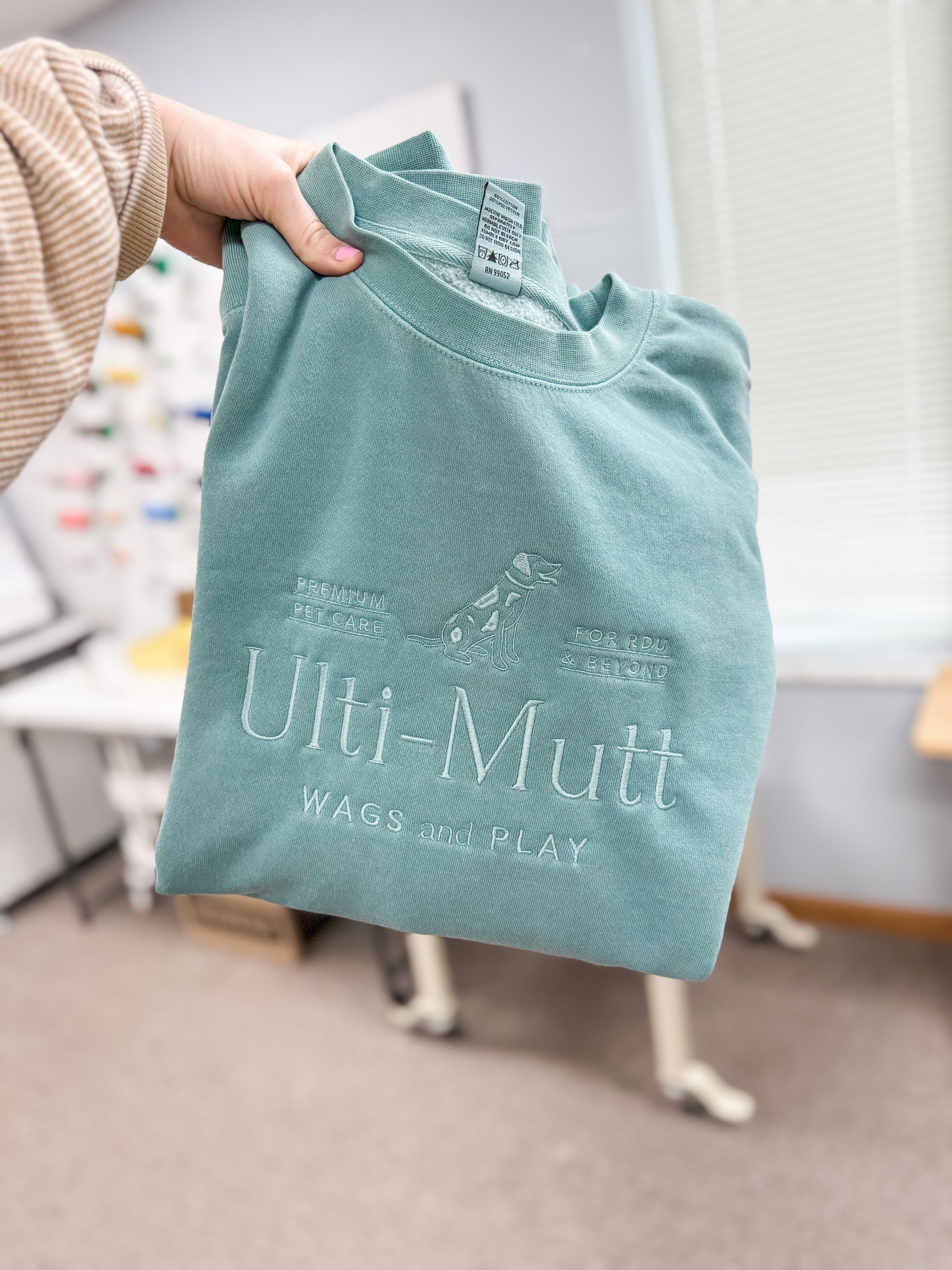 Dog logo embroidered on sweatshirt